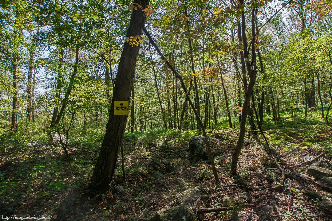 blue trail no tresspassing sign